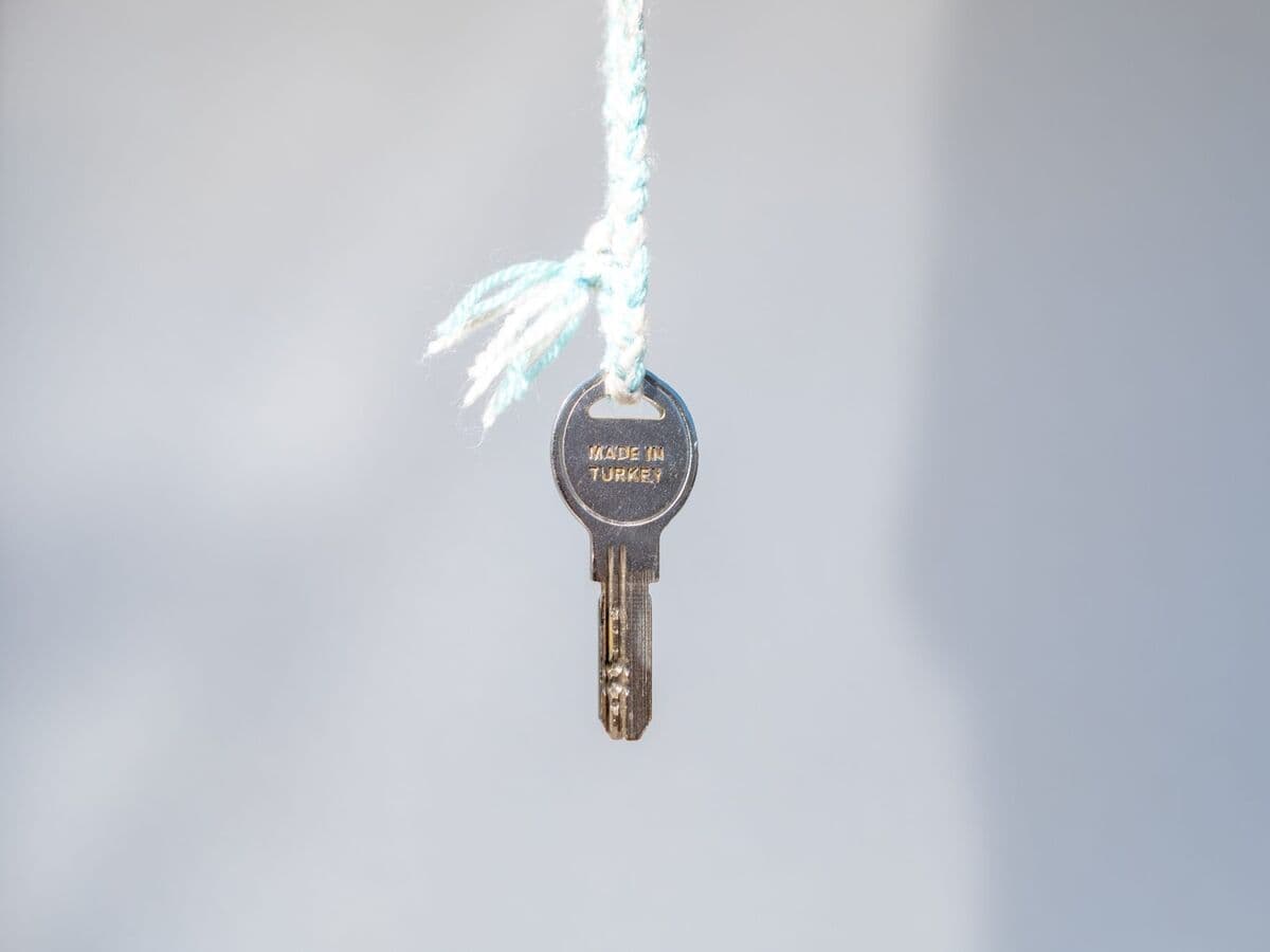 House key hanging on a string